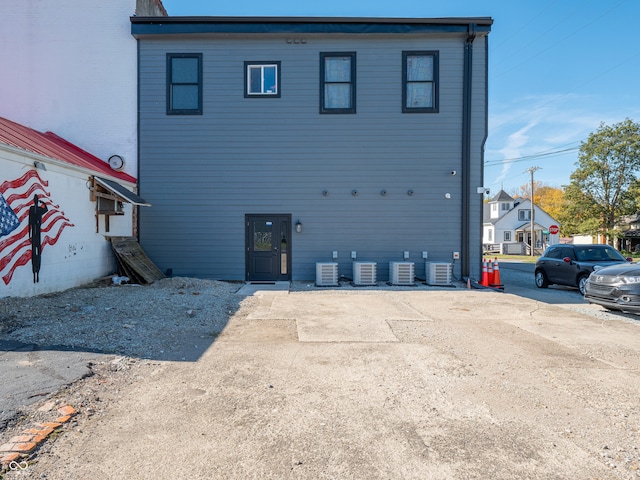 back of house featuring central AC unit