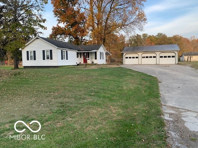 single story home with an outbuilding, a front yard, and a garage