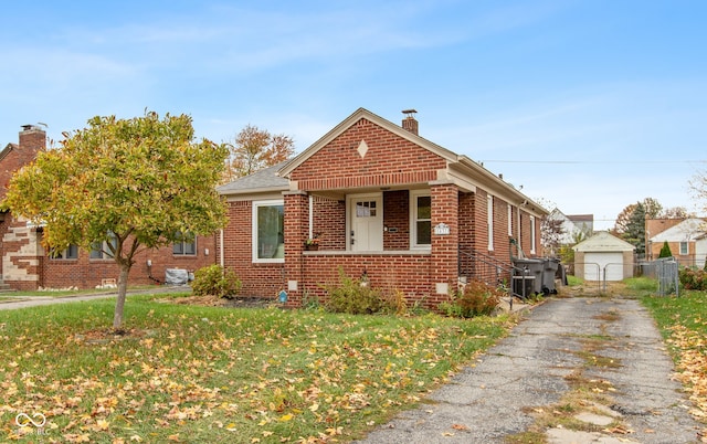 bungalow-style home with a garage and a front lawn