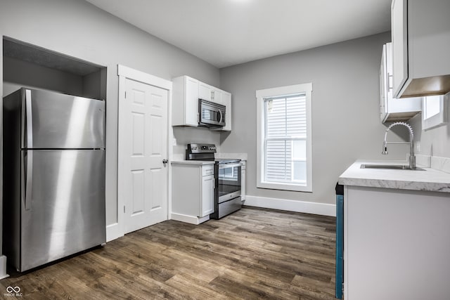 kitchen with white cabinets, sink, dark wood-type flooring, and appliances with stainless steel finishes