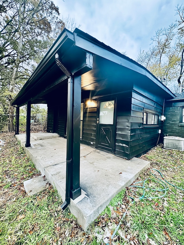 view of side of property featuring central AC