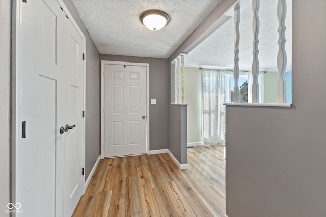 interior space with light wood-type flooring and a textured ceiling