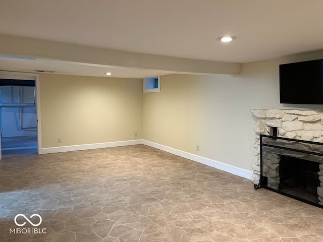 basement with a stone fireplace