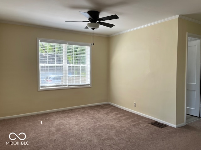 carpeted spare room featuring ceiling fan and crown molding