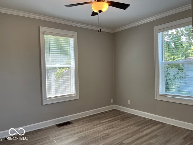 unfurnished room featuring ceiling fan, hardwood / wood-style floors, and ornamental molding