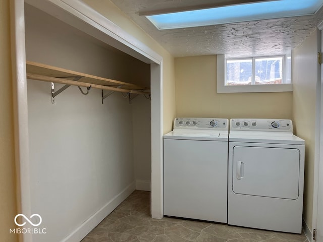 washroom with washing machine and dryer and light tile patterned floors