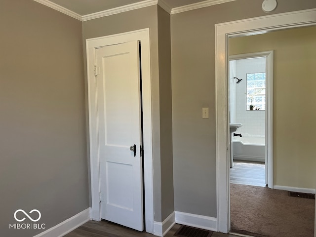 hall with dark hardwood / wood-style flooring and crown molding