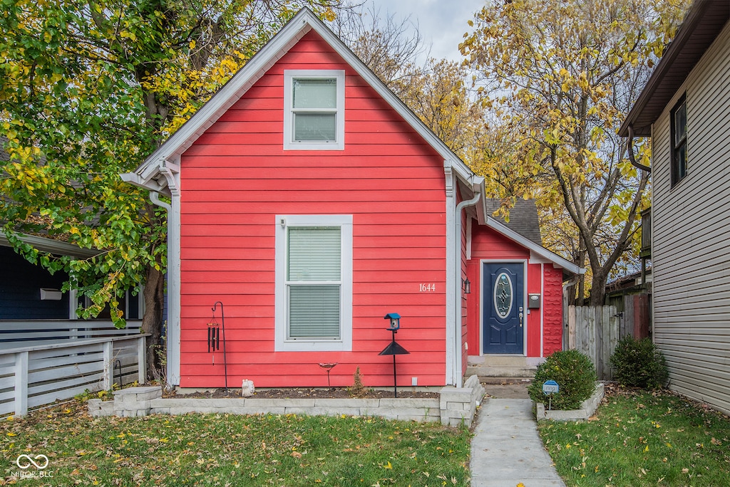 bungalow-style home with a front yard