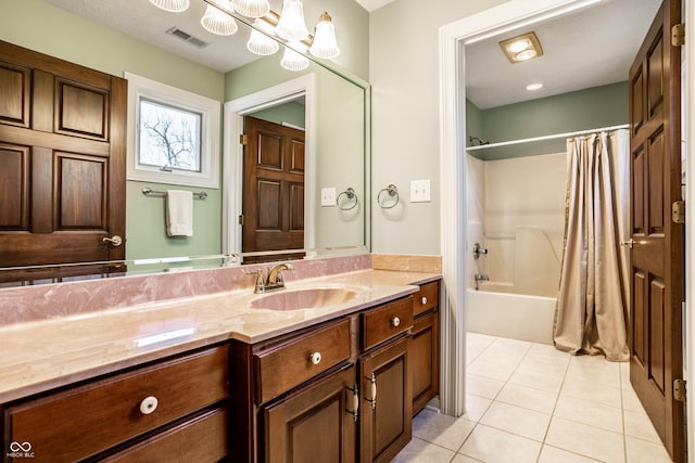 bathroom with tile patterned flooring, shower / bath combination with curtain, vanity, and an inviting chandelier