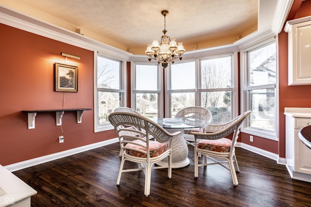 dining room featuring a textured ceiling, dark wood-type flooring, and a chandelier