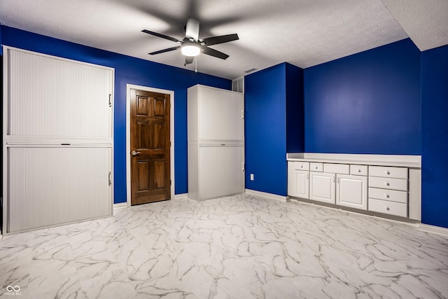 unfurnished bedroom with a textured ceiling and ceiling fan