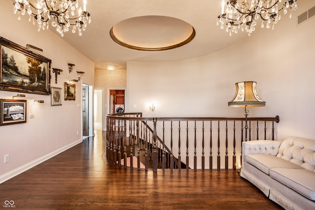 corridor featuring dark hardwood / wood-style floors, a towering ceiling, and washer / clothes dryer