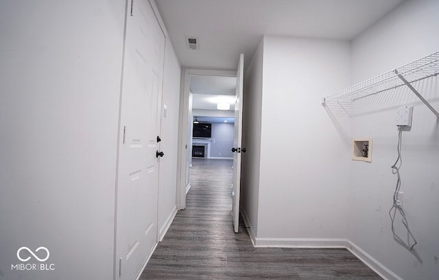 washroom featuring hookup for a washing machine and dark wood-type flooring