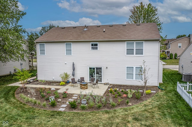 rear view of house with a yard and a patio