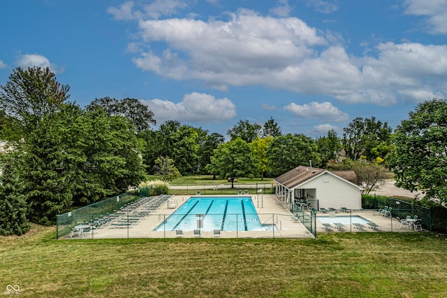 view of pool with a patio area, a yard, and an outbuilding