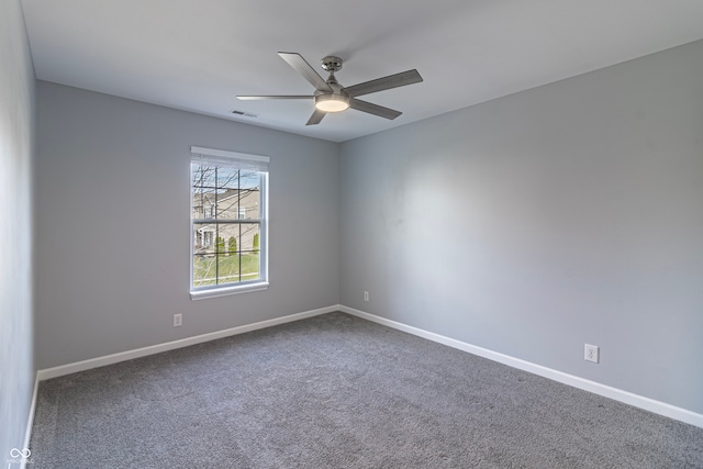 carpeted spare room with ceiling fan