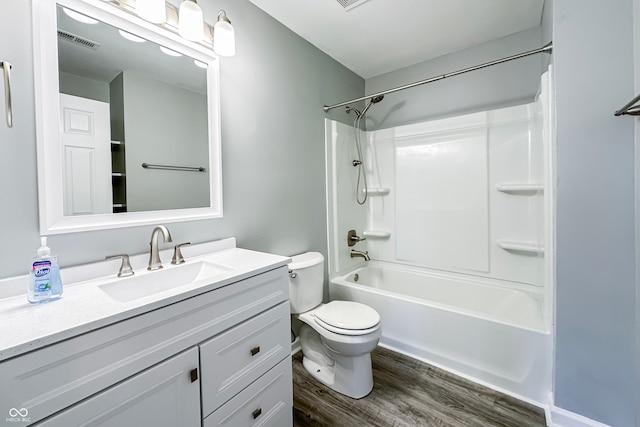 full bathroom with vanity,  shower combination, hardwood / wood-style flooring, and toilet