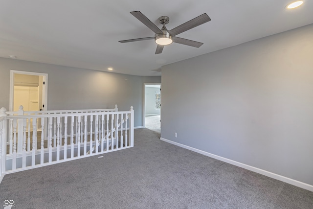 unfurnished room featuring ceiling fan and carpet floors