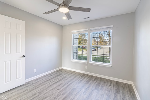 empty room with light hardwood / wood-style flooring and ceiling fan