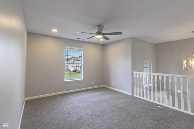 carpeted spare room with ceiling fan