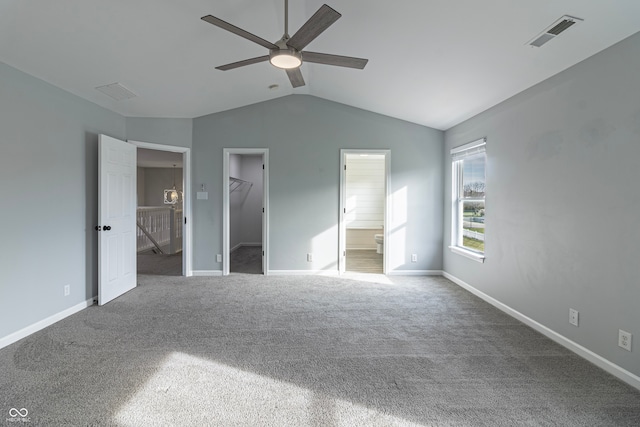 unfurnished bedroom with a spacious closet, ceiling fan, ensuite bathroom, carpet floors, and a closet