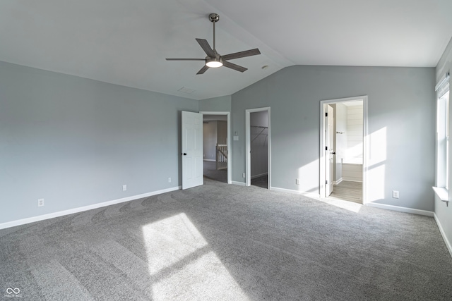 unfurnished bedroom featuring carpet, ceiling fan, a spacious closet, connected bathroom, and a closet