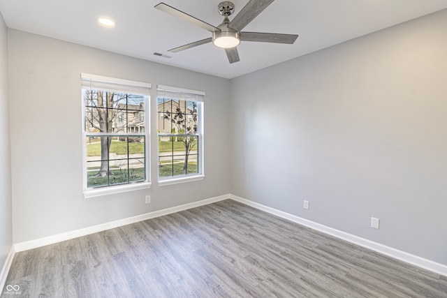 unfurnished room with ceiling fan and light wood-type flooring