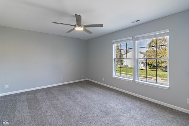 carpeted spare room with ceiling fan