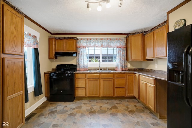 kitchen featuring a textured ceiling, black appliances, sink, and crown molding