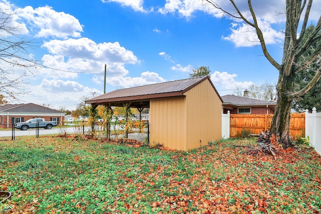 view of side of property featuring a storage shed