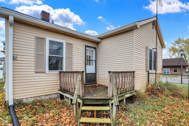 rear view of house featuring a wooden deck