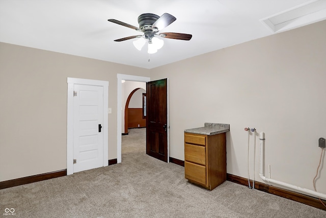 unfurnished bedroom with light colored carpet and ceiling fan