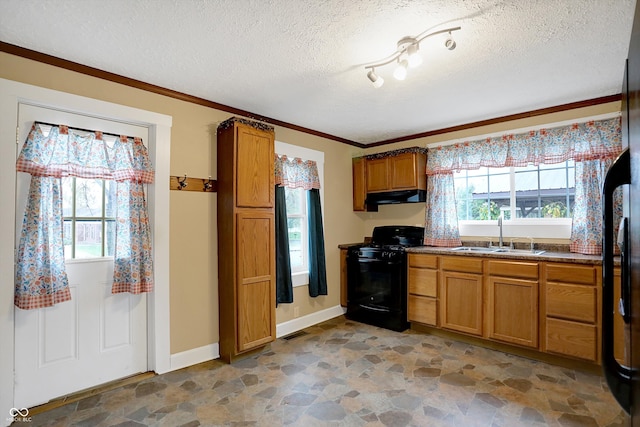 kitchen featuring a healthy amount of sunlight, black stove, a textured ceiling, and sink