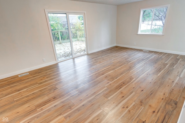 empty room with light hardwood / wood-style flooring