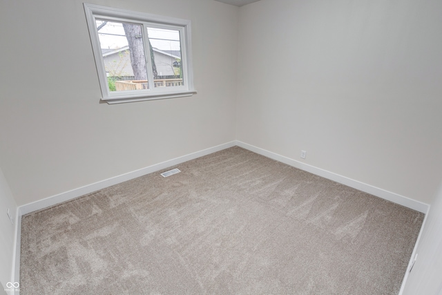 spare room with light colored carpet