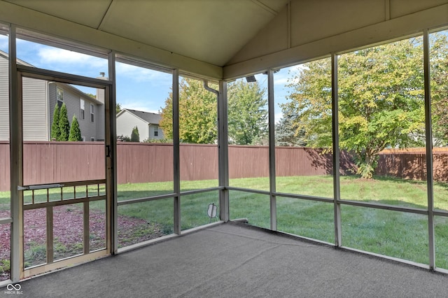 unfurnished sunroom featuring lofted ceiling