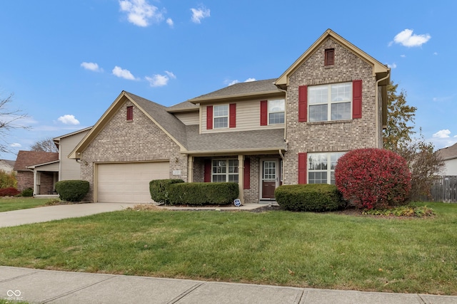 traditional-style house with brick siding, an attached garage, a front lawn, and concrete driveway