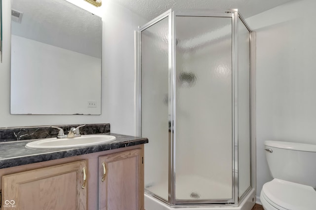 full bath with a stall shower, toilet, and vanity