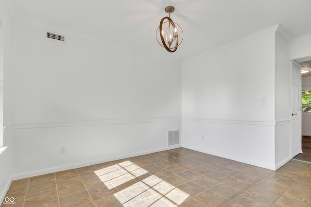 tiled spare room featuring a chandelier, ornamental molding, and baseboards
