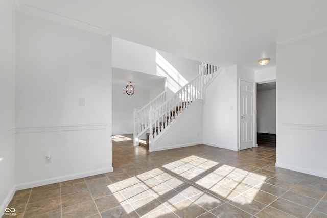 tiled spare room with ornamental molding