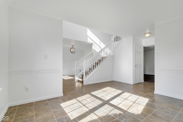 unfurnished living room with stairway, baseboards, tile patterned floors, and ornamental molding