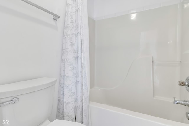 bathroom with toilet and shower / bath combo with shower curtain