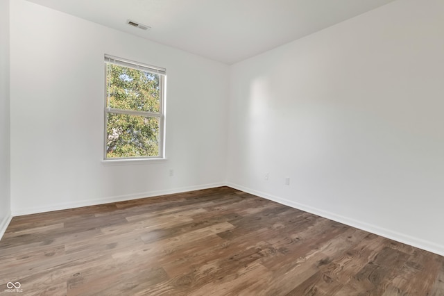 empty room featuring baseboards and wood finished floors