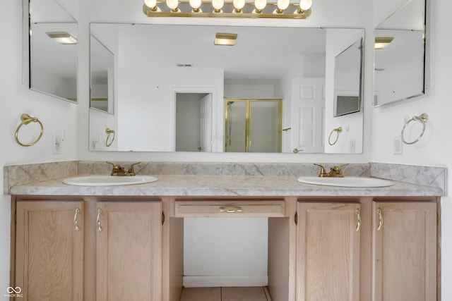 bathroom featuring a stall shower, double vanity, and tile patterned flooring