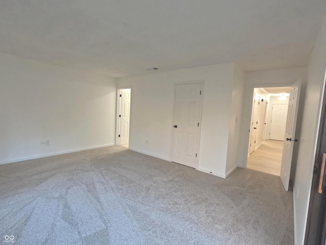 unfurnished bedroom with light colored carpet