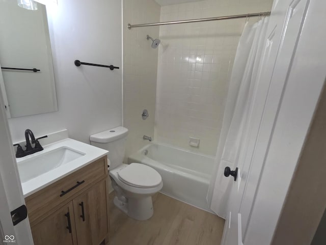 full bathroom with shower / tub combo with curtain, vanity, wood-type flooring, and toilet