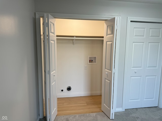 laundry room with washer hookup and light wood-type flooring