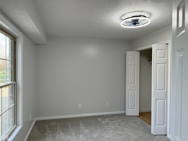 unfurnished bedroom featuring carpet floors and a textured ceiling