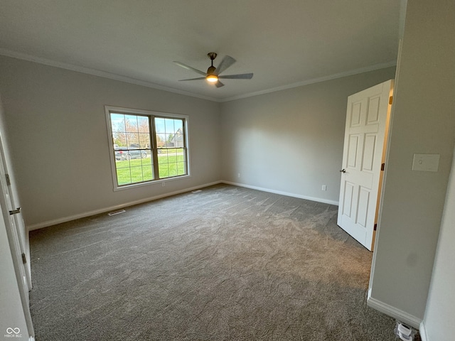 carpeted empty room featuring ceiling fan and crown molding