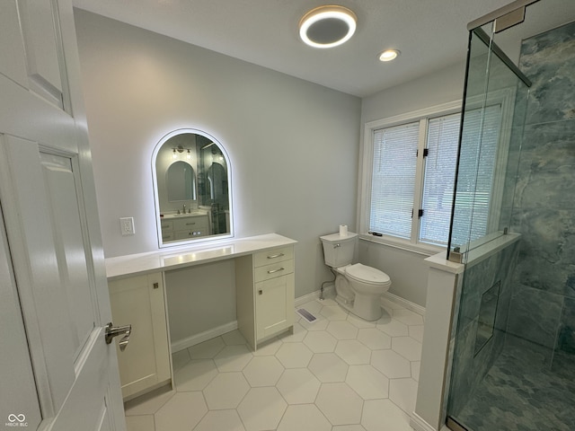 bathroom featuring walk in shower, tile patterned flooring, vanity, and toilet